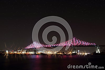 Jacques Cartier Bridge Illumination in Montreal, reflection in water. Montrealâ€™s 375th anniversary. Stock Photo